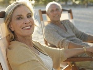 a senior couple lounging in beach chairs