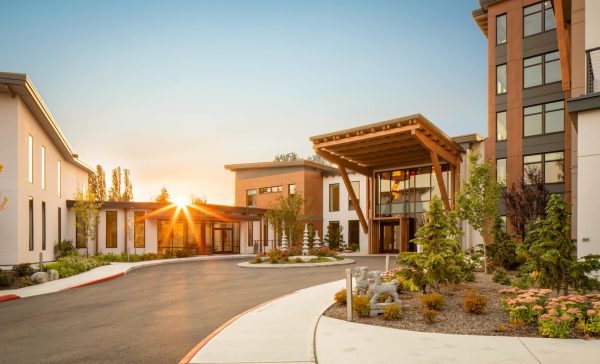 The main entrance of Aegis Gardens with the sun setting in the background.