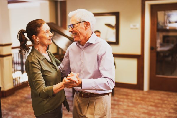 An older couple happily dancing.