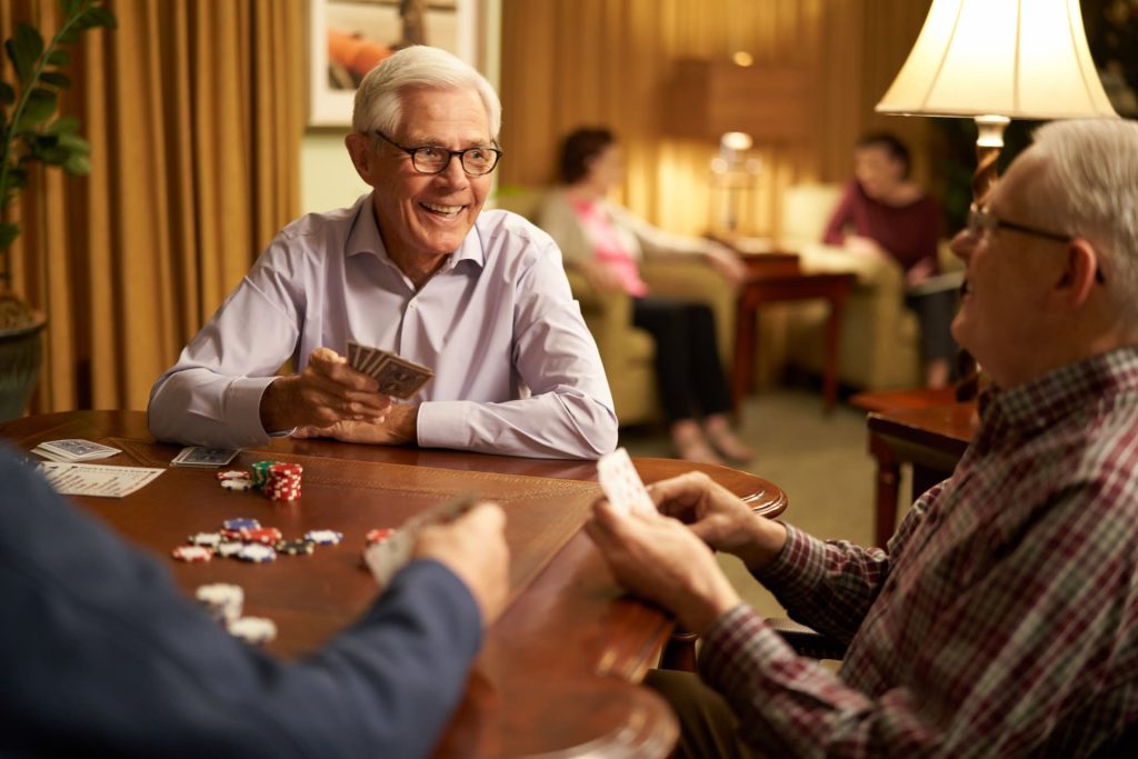 Residents sitting at a table playing cards