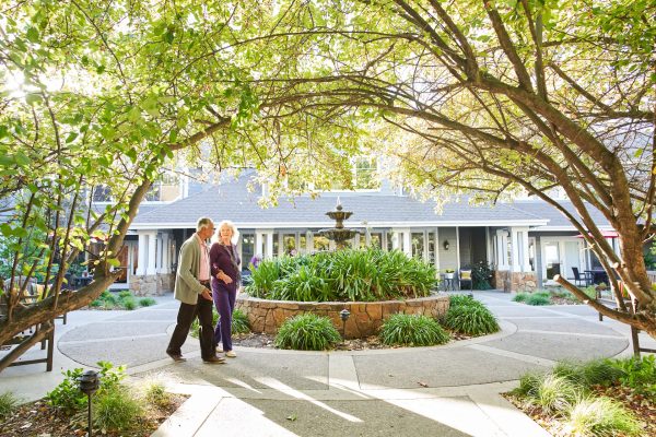 Two residents walking outside of Aegis Living