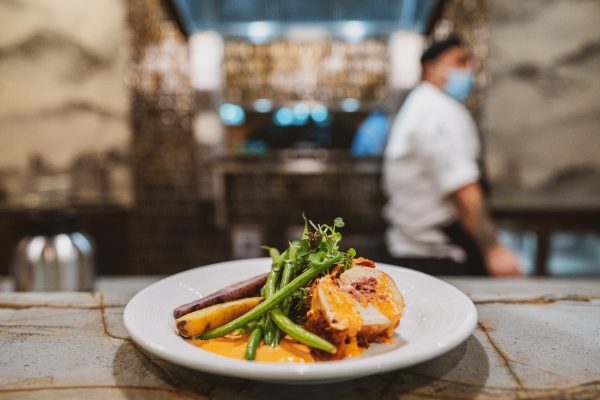 An elegant plate of pork, green beans, and carrots