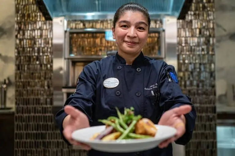 aegis chef presenting a dish