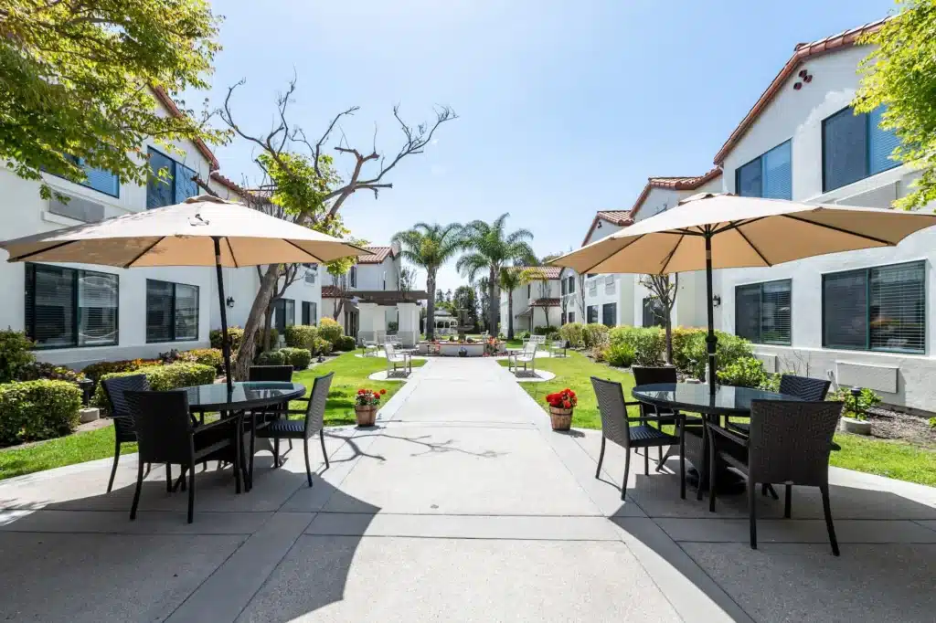 an outside patio with covered tables and chairs