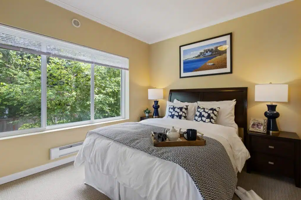 Cozy bedroom with large window view.