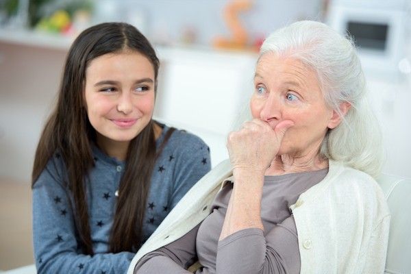 a girl talking to her grandmother.