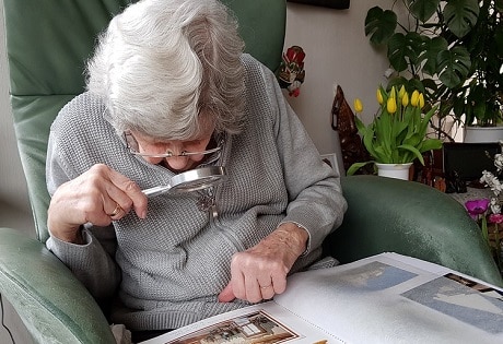 woman reading with magnifier