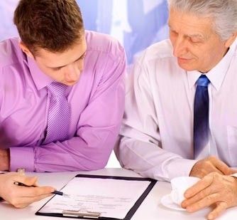 Men discuss contents of a document on clipboard