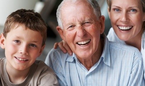 Father, daughter and grandson pose for camera