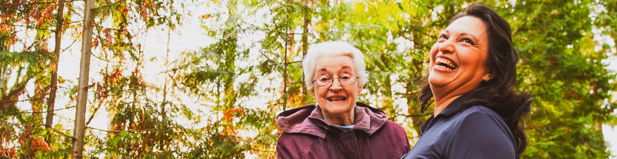 A resident and an employee laughing outside