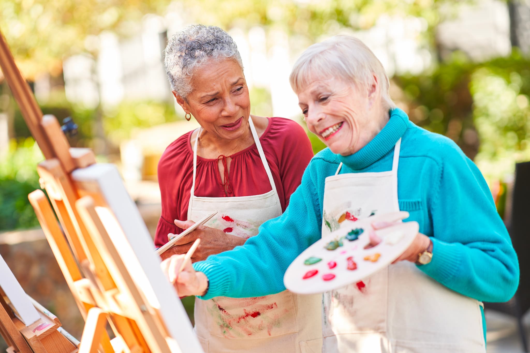 Two residents painting outside