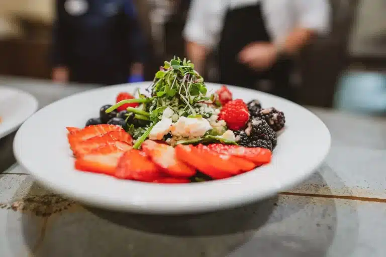 Plate of fresh fruit and greens salad
