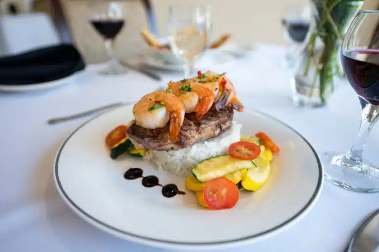 Gourmet shrimp steak on rice with vegetables.