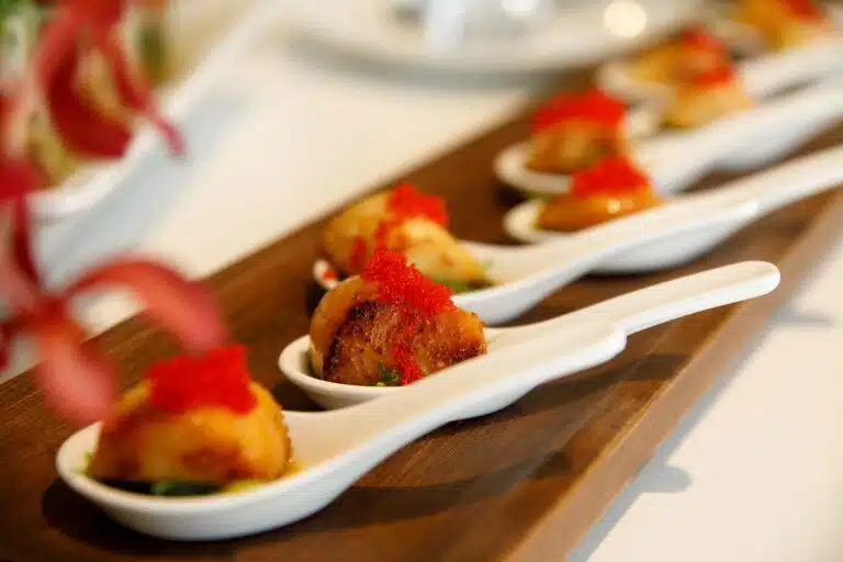 Scallops with red roe on spoons